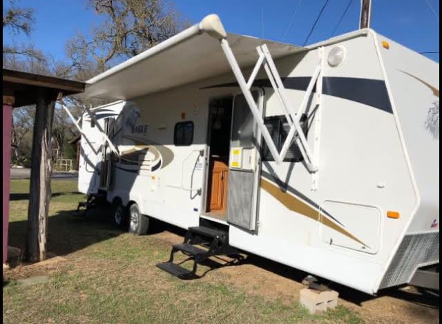 2010 Jayco Eagle 324 BHDS travel trailer, exterior side view with awning out